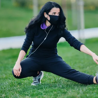 A woman stretching outdoors.