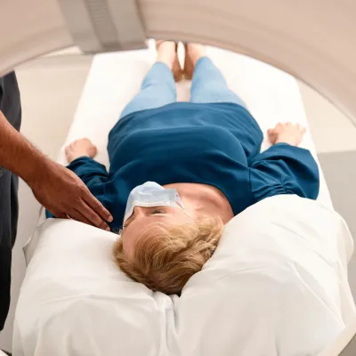 Woman wearing a mask getting an MRI