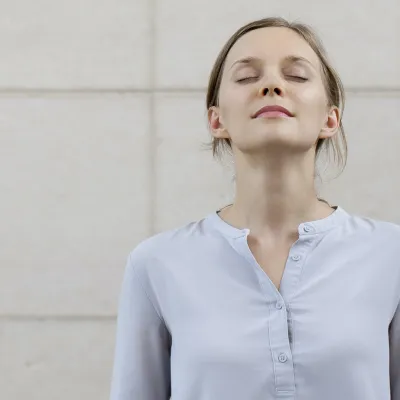 A woman takes a deep breath to stay calm during a lab test