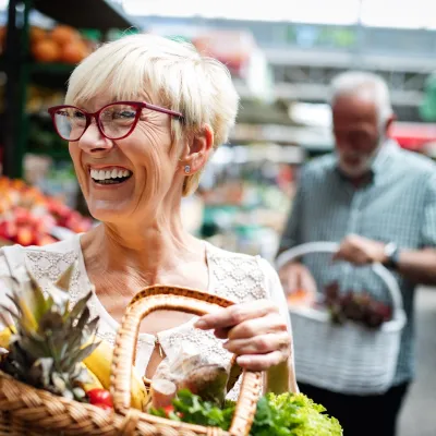 Happy older woman shopping.