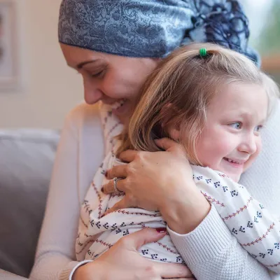 A mother and daughter hugging.