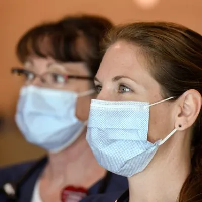 2 women wearing masks