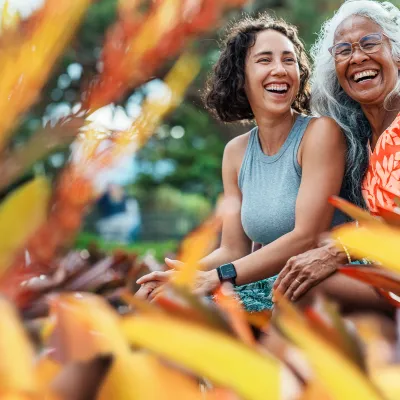 mom and daughter smiling in a garden