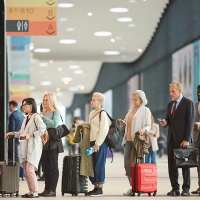 A group of people waiting to check in at the airport.