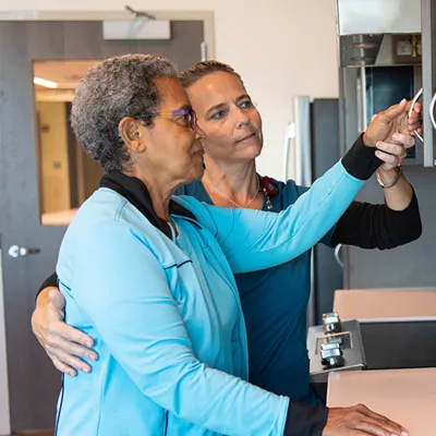 A nurse's woman helping a patient.
