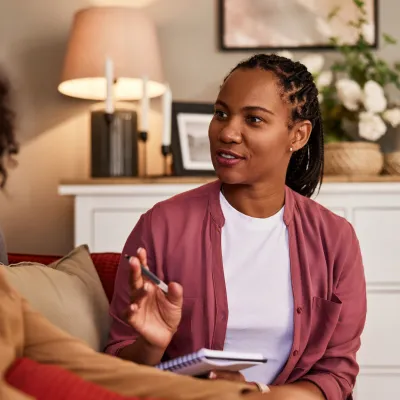 Mental health provider speaking to young client.