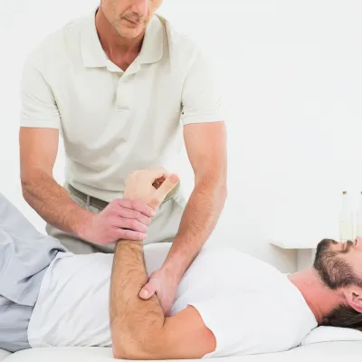 Athletic trainer helping athlete