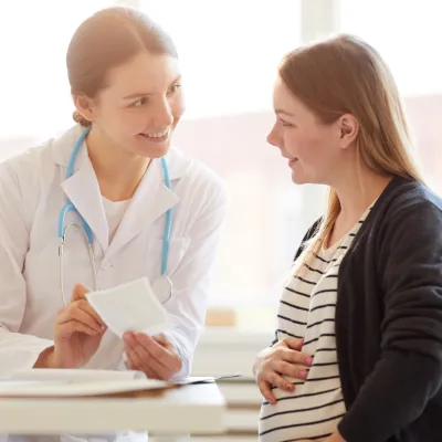 doctor speaking with pregnant woman
