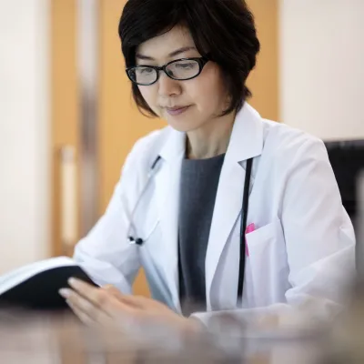 A female doctor reviews materials. 