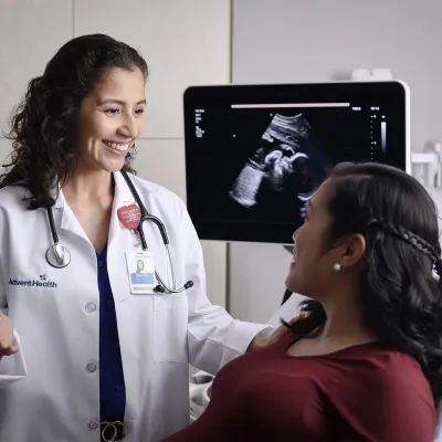 A pregnant woman talking to her doctor about imaging results