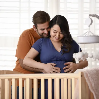 Happy expectant parents embracing