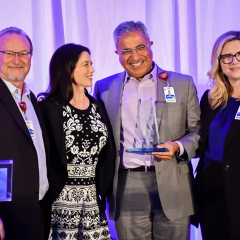 Dr. Raj winning Physician of the Year Award