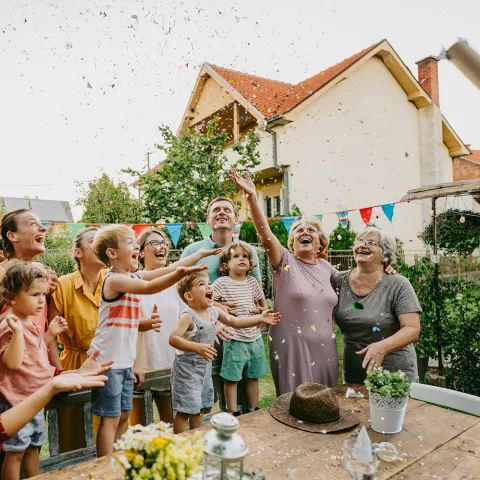 Group of people celebrating together outdoors.