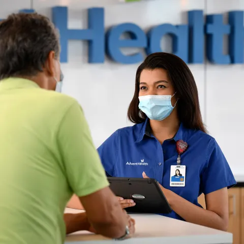 An AdventHealth employee helping out a gentleman