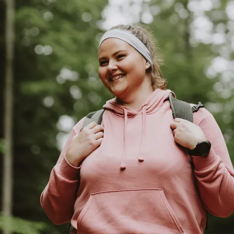 A Woman Hikes Through the Woods