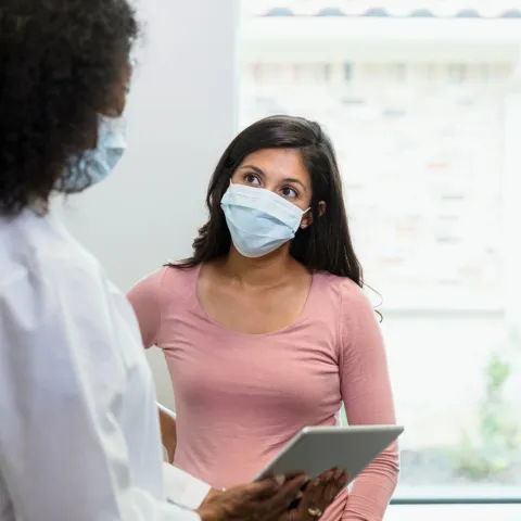 A patient listening to her provider with attention