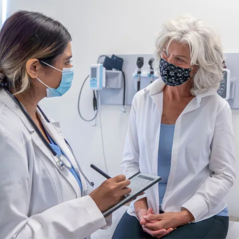 A female patient listening to her female physician.
