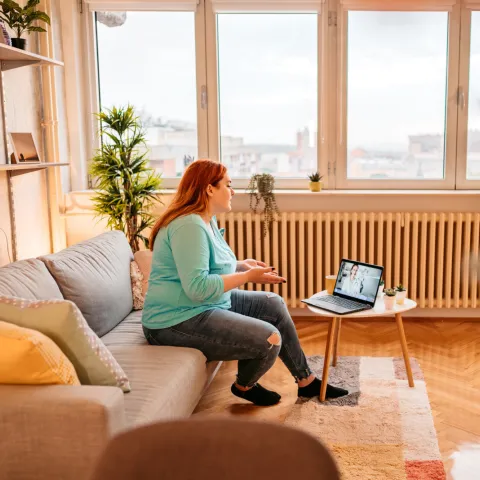 A Patient Speaks to Her Doctor Via Laptop During a Telehealth Visit