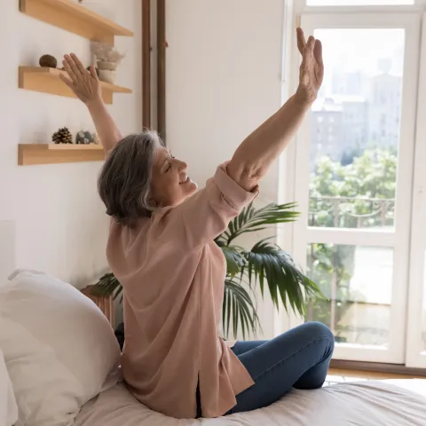 A Woman Stretches After Waking From Sleep