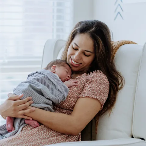 A New Mother Holds Her Baby While They Sleep.