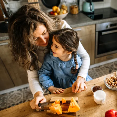 A Mother and Her Young Daughter Bake in Their Kitchen