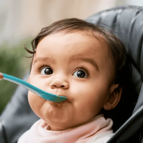 A Close Up of a Baby Being Spoon Fed