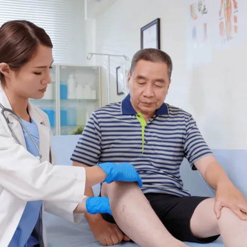 Doctor checking patient's leg