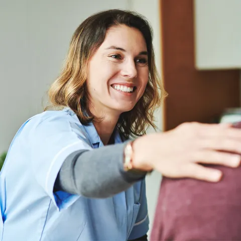 A Nurse Comforts a Senior Patient