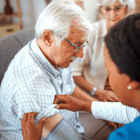 A Senior Man Has His Blood Pressure Taken by a Medical Professional