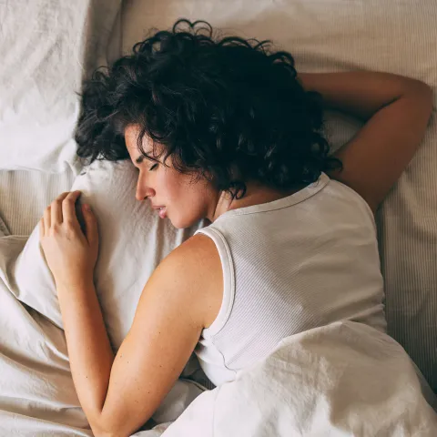 A woman sleeping in bed.