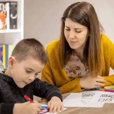 A Mother Helps Her Child with His Homework