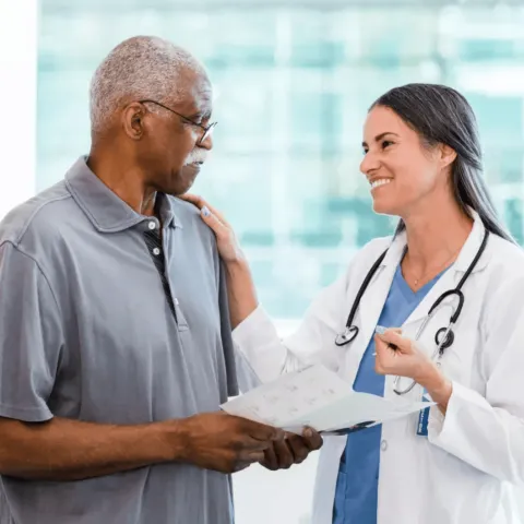 Man with doctor reviewing pamphlet