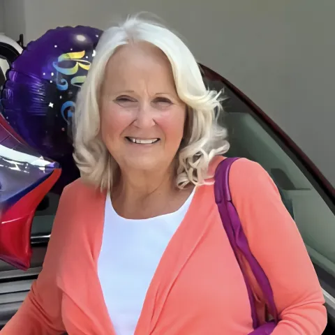 Peggy posing with balloons.