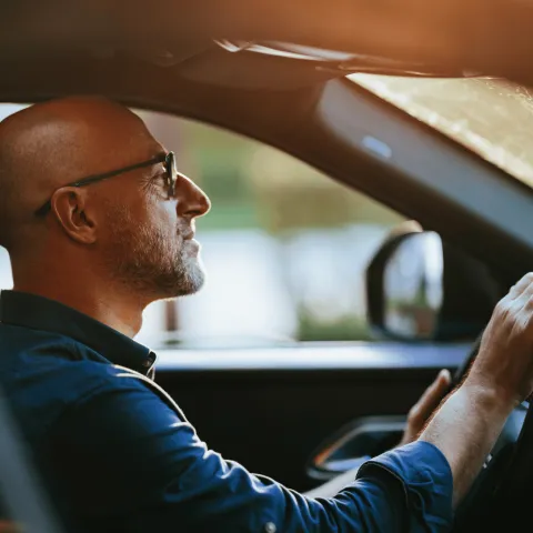 Bald Man Driving Car