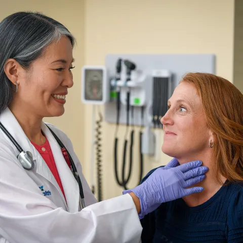 Physician examining patient's throat