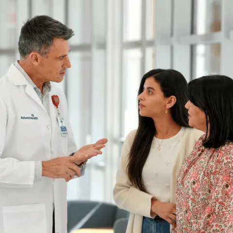 A Physician Speaks with Two Patients in a Waiting Room