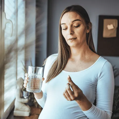 Woman taking pregnancy pill