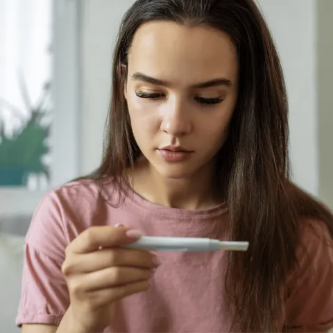 Woman looking at pregnancy test