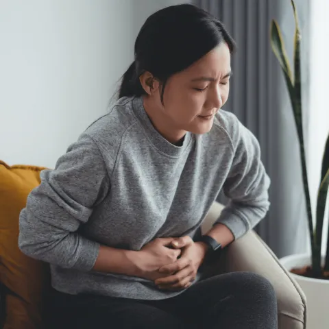 Woman grabbing her stomach 