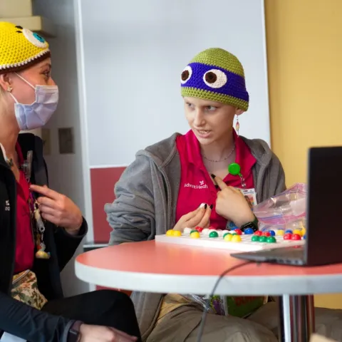 Alexis and a Child Life Specialist running bingo
