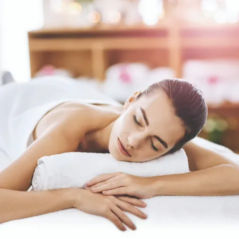 A woman relaxing in a massage parlor. 