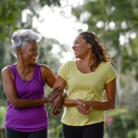 Mother and daughter walking outside