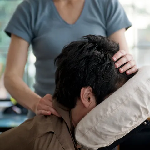 Woman getting a massage in a massage chair.