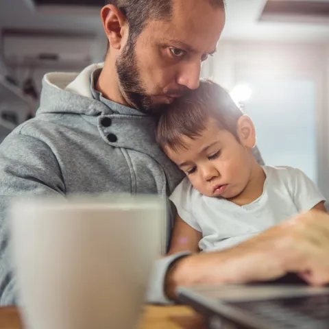 Father and son on the computer together.