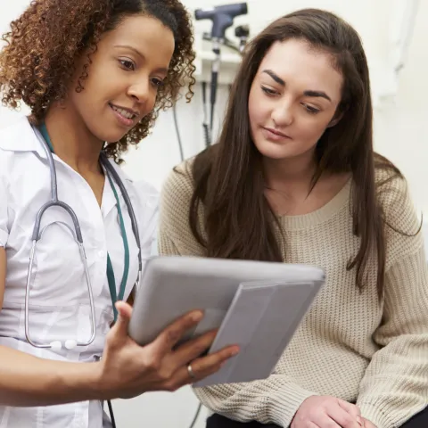 A young woman consults with her physician.