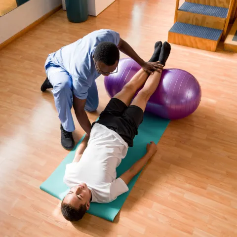 Physical Therapist working on stretching with patient