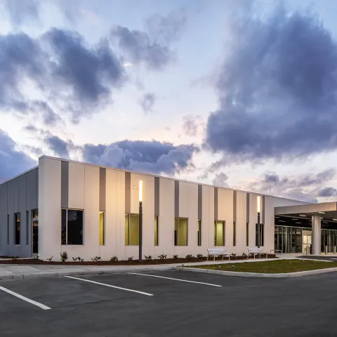 Exterior of AdventHealth Care Pavilion Heathbrook in the evening.