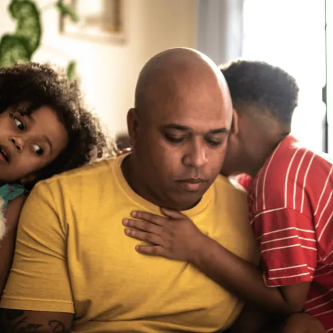 A tired-looking father with his two children.