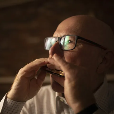 Man playing a harmonica