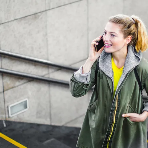 A woman walking up stairs while talking on the phone